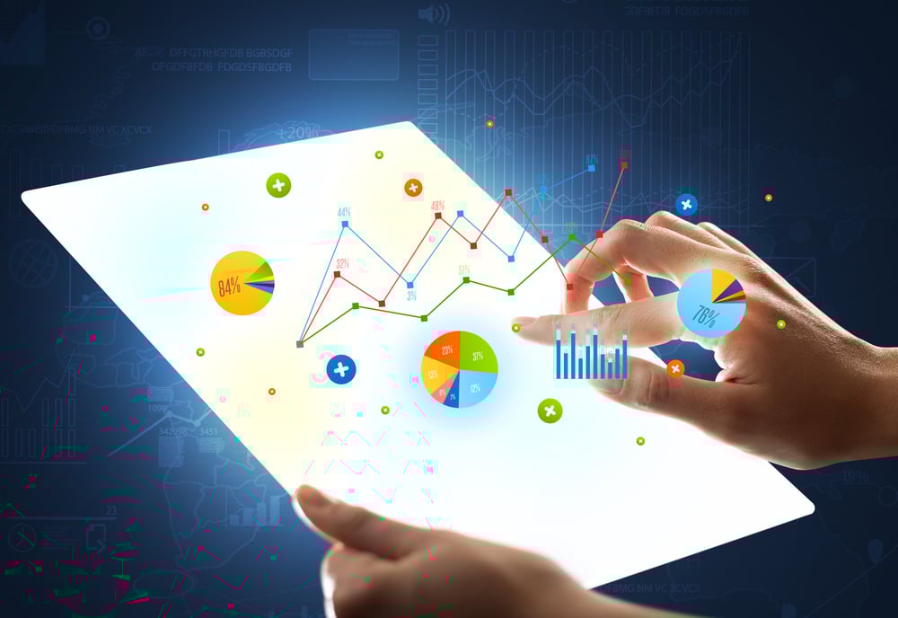 Young female hand holding a tablet with colorful charts